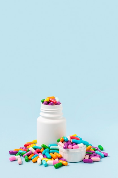 Colorful pills in white bottle