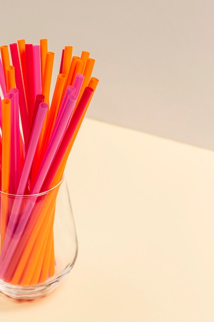 Free photo colorful plastic straw collection in glass