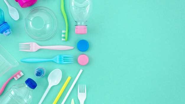 Colorful plastic tableware on turquoise background