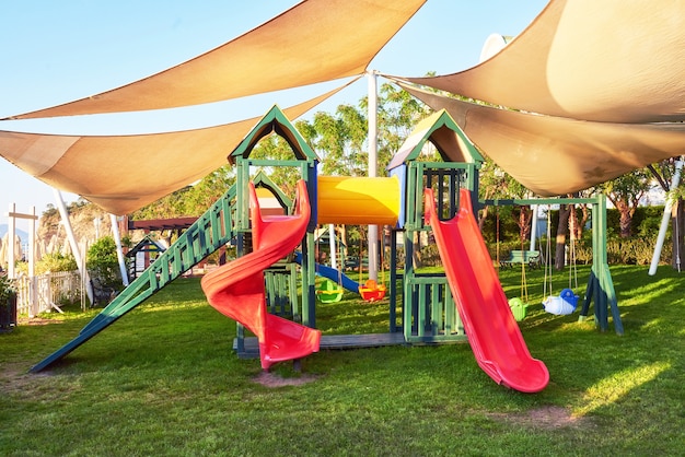 Colorful playground in the yard in the park at sunset.