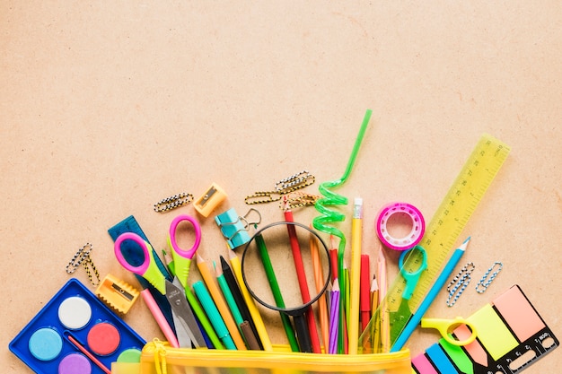Colorful school equipment on plain background