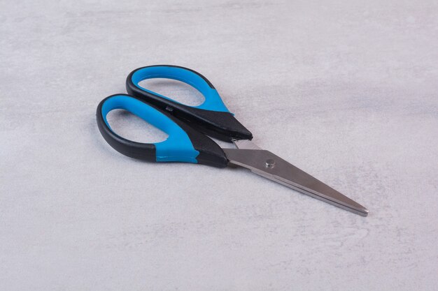 Colorful sharp scissors on white surface