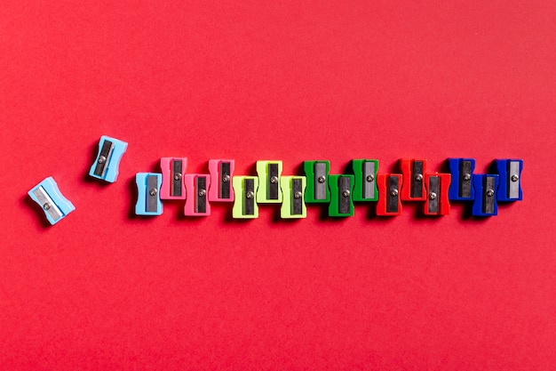 Free photo colorful sharpeners on red table