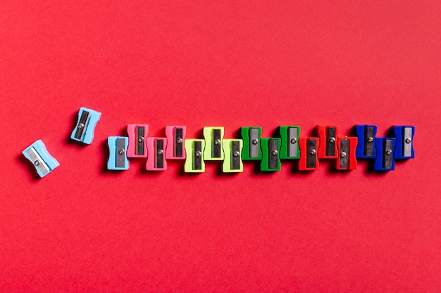 Colorful sharpeners on red table
