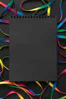 Free photo colorful shoelaces arrangement with black notepad