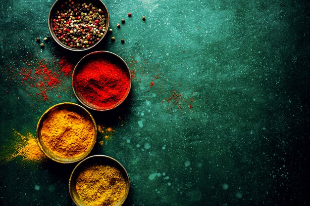 Colorful spices on dark table