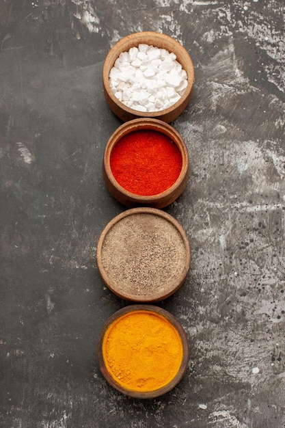 Free photo colorful spices four bowls of colorful spices on the black table