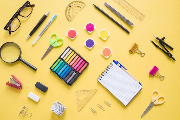 Colorful stationeries on yellow background