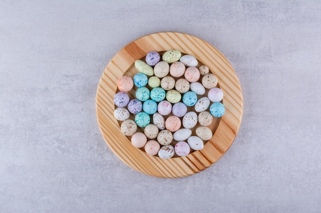 Colorful stone candies in trays on concrete background. High quality photo