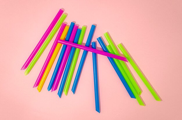 Colorful  straws on a pink background