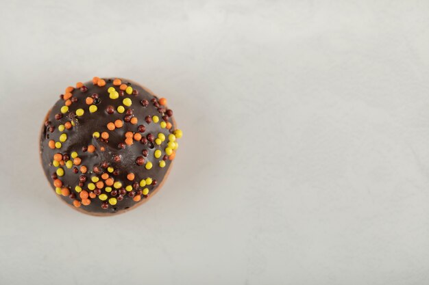 Colorful sweet small doughnut with sprinkles.