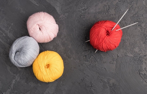 Colorful wool yarn on slate background