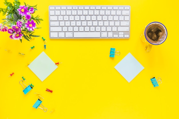 Colorful workspace with keyboard and coffee