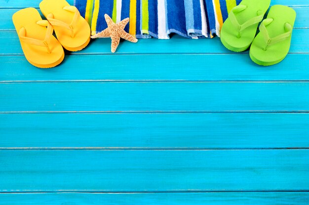 Coloured flip flops and summer towel