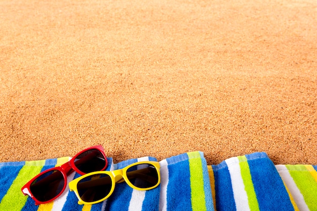 Coloured sunglasses on the beach