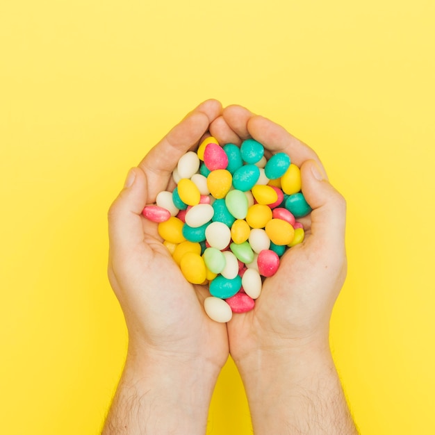 Free photo colourful candies in palms