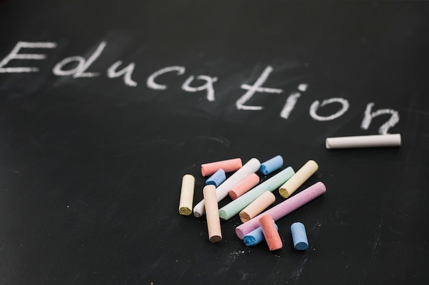 Colourful chalks on black board 