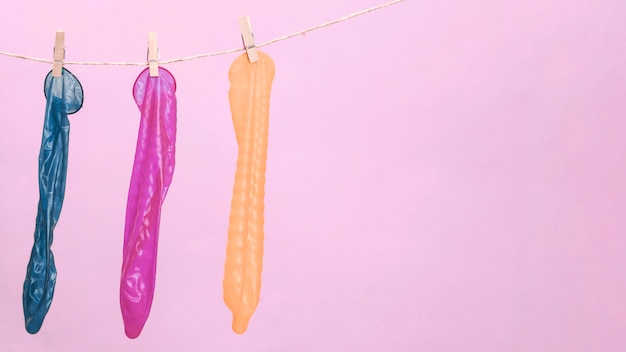 Colourful condoms with clothespin and copy-space