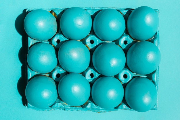 Colourful Easter eggs in rack on table