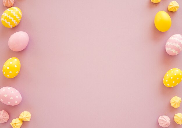 Colourful Easter eggs with small sweets on table