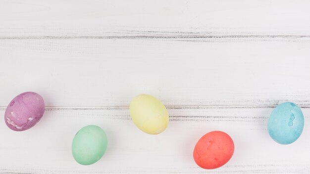 Colourful Easter eggs on wooden table