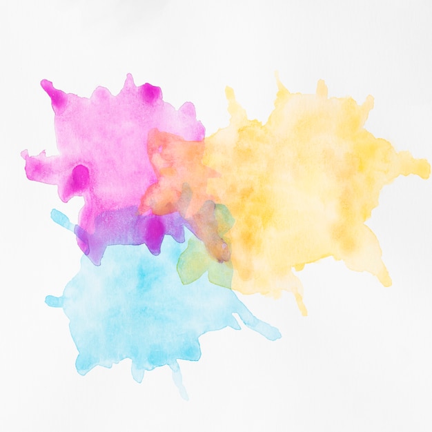 Free photo colourful hand painted stains on white surface