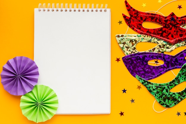 Free photo colourful masks and blank notepad