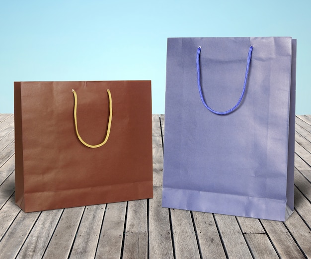 Colourful paper shopping bags on wooden floor