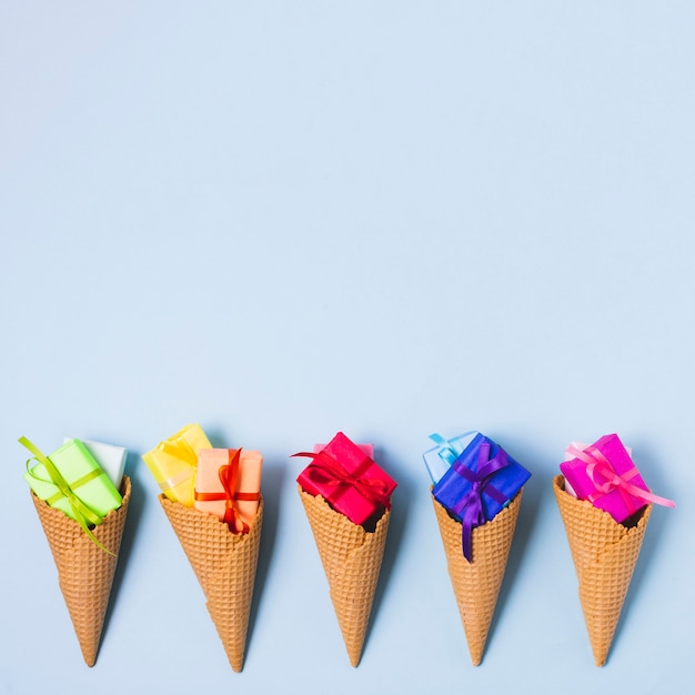 Free photo colourful present in ice cream cones with copy space