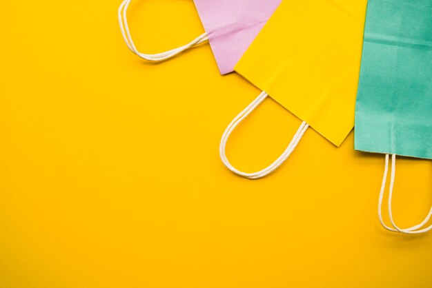 Colourful shopping bags on table 