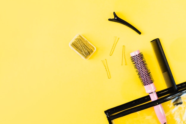 Combs and hairpins near cosmetics bag