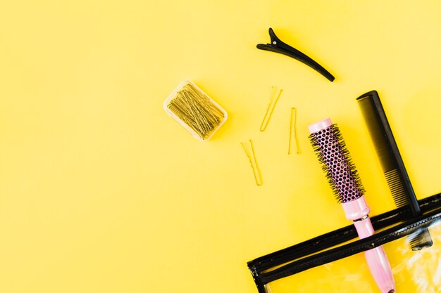 Combs and hairpins near cosmetics bag