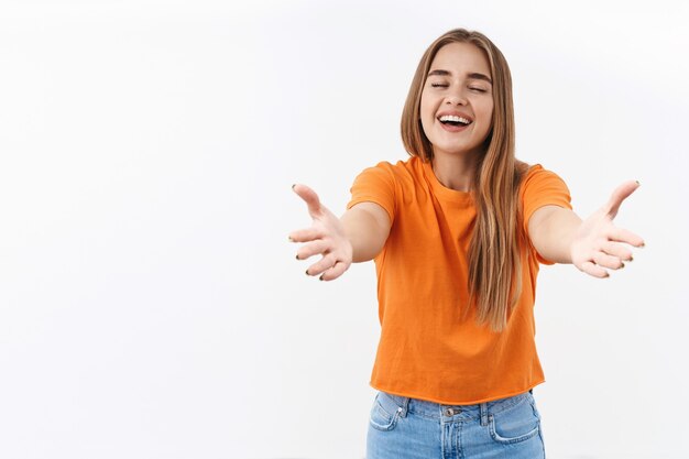 Come to me, let me embrace you. Portrait of happy, friendly cheerful blond girl