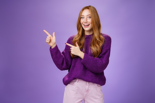 Come in portrait of friendlylooking cheerful pretty ginger girl in purple sweater inviting us visit ...