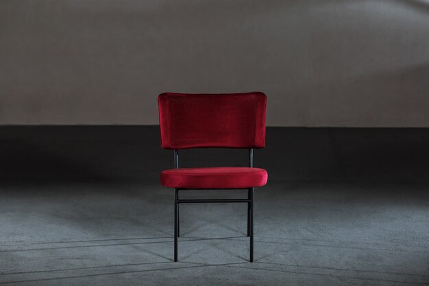 Comfy red wing chair in a room with gray walls