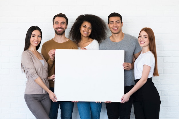 Community of young people holding a sign