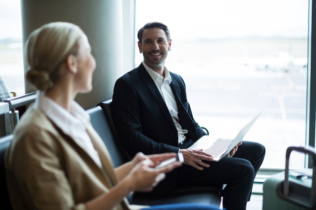 Commuters interacting with each other in waiting area