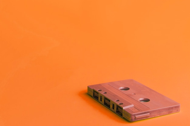 Free photo compact cassette on orange background