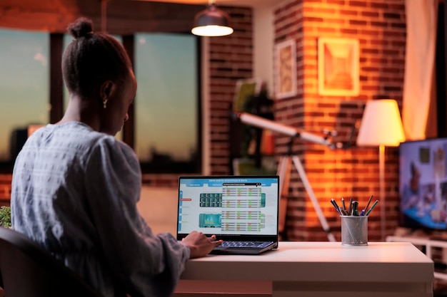 Company bookkeeper analyzing financial statistics on laptop screen, corporate accounting service concept. Business analyst looking at diagrams and charts on computer in modern workspace