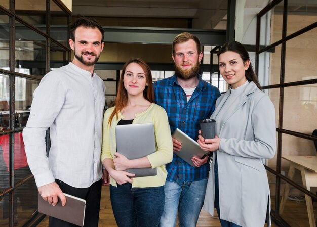 Company colleagues stand with confident expression