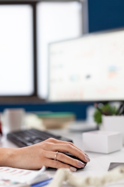 Company executive in his office using and clicking on mouse