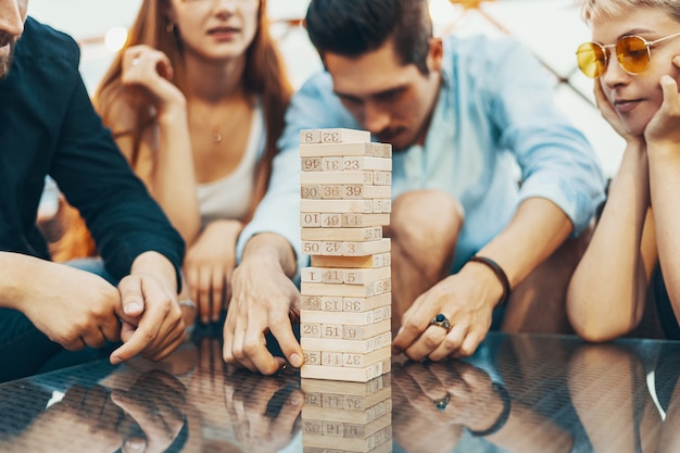 The company of young people playing board game