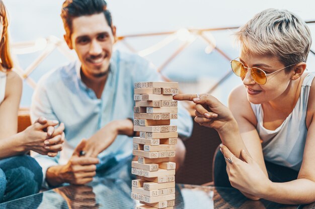 The company of young people playing board game