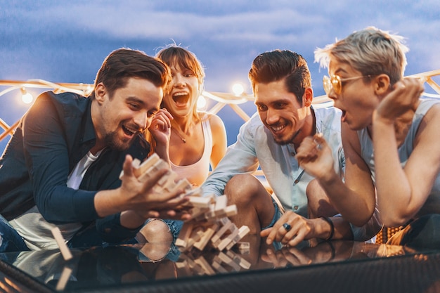 The company of young people playing board game