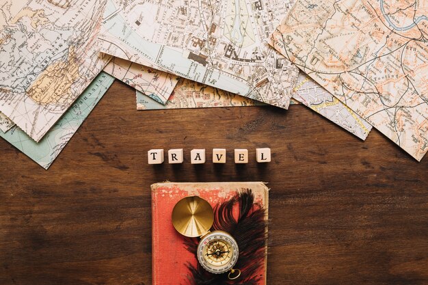 Compass and feather near writing and maps