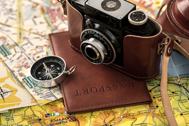 Compass and passport on map high angle