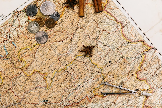 Free photo compasses, spices, envelope lie on old yellow map