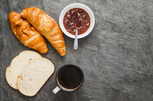 Composed bakery with coffee and marmalade