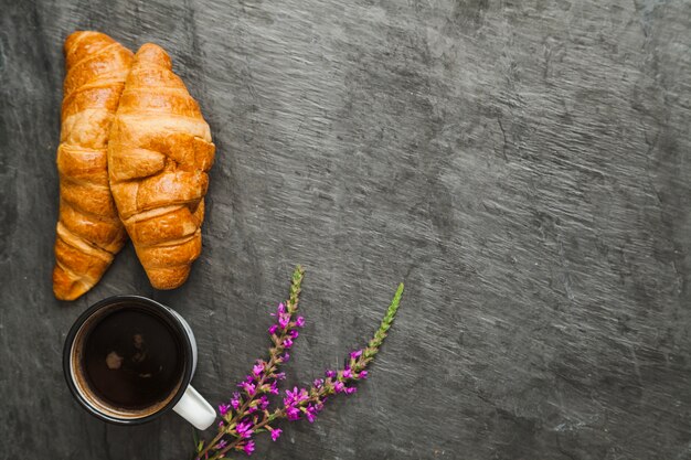 Composed coffee and fresh bakery on gray