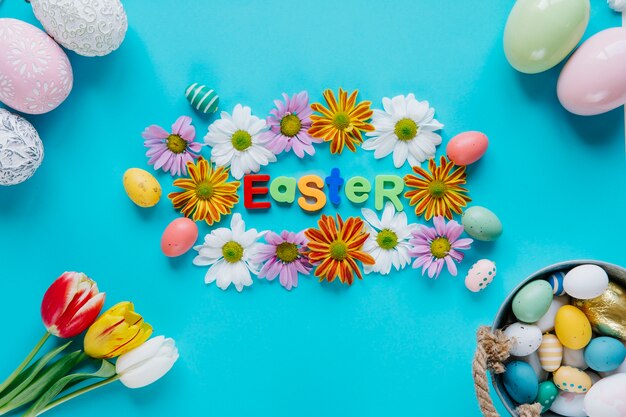 Composed Easter eggs and flowers on blue